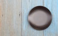Black plate on wood table background Royalty Free Stock Photo