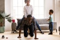 Black playful father ride daughter on his back indoors Royalty Free Stock Photo