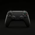 A black PlayStation 4 DualShock controller is centered against a dark Royalty Free Stock Photo