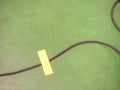 Black plug electrical power strip on polished green floor