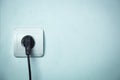 Black plug inserted in electrical outlet. Royalty Free Stock Photo