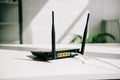 Black plugged router on white office Royalty Free Stock Photo