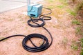 Black pneumatic tube along the road to measure speed and number of vehicles