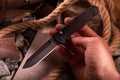 Black pocket knife in hand. Automatic folding knife