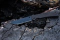 Black pocket knife in the ruins. Royalty Free Stock Photo