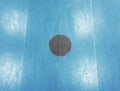 Black point in blue playfield. Painted wooden floor of sports hall