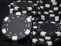 Black poker chips round and plastic on a dark background. Concept gambling Royalty Free Stock Photo