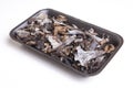 Black polythene tray full of Horn of Plenty mushrooms Royalty Free Stock Photo