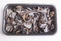 Black polythene tray full of Horn of Plenty mushrooms Royalty Free Stock Photo