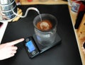 Black porous ceramic paperless coffee filter on glass jug. Gooseneck kettle. Electronic scale. Manual brewing still life