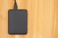 Black portable hard drive with a cable