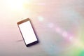 Black portable phone on wooden isolated white table