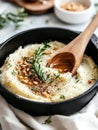 A black pot of mashed potatoes with a wooden spoon in it Royalty Free Stock Photo