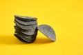 Black potato chips on yellow background. Black chips with activated charcoal and red pepper.