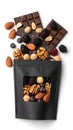 Black pouch filled with chocolate nuts and dried fruit mix Royalty Free Stock Photo