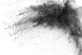 Black powder explosion. The particles of charcoal splatter on white background Royalty Free Stock Photo