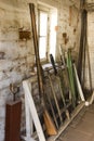 Black powder rifle stands in a rack against a brick wall in a dirty room