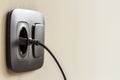 Black power cord cable plugged into european wall outlet on whit Royalty Free Stock Photo