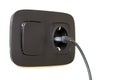 Black power cord cable plugged into european wall outlet on whit Royalty Free Stock Photo
