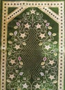 The Green prayer rug is a device made of cloth that usually has an Islamic image and style. Prayers are used by Muslims to keep Royalty Free Stock Photo