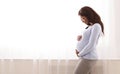 Black pregnant woman hugging her tummy at home Royalty Free Stock Photo