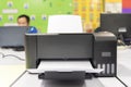 A black printer is open and has a white sheet of paper inside Royalty Free Stock Photo