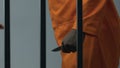 Black prisoner with knife attacking Caucasian cellmate behind prison bars