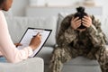 Black Psychiatrist Lady Filling Questionnaire During Therapy Meeting With Depressed Military Woman