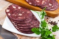 black puddingon served with parley on plate on wooden table Royalty Free Stock Photo