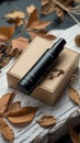 Black pump bottle on beige box with autumn leaves and dried twigs image photo Royalty Free Stock Photo