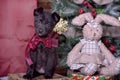 Black puppy and toy bunny Royalty Free Stock Photo