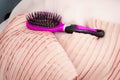 Black and purple hair brush on pink pillows Royalty Free Stock Photo