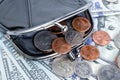 Black purse with cents on the background of hundred-dollar bills Royalty Free Stock Photo