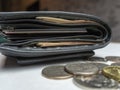 Black purse with paper and iron money top view Royalty Free Stock Photo