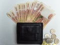 Black purse with paper and iron money top view Royalty Free Stock Photo