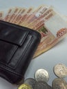 Black purse with paper and iron money Royalty Free Stock Photo