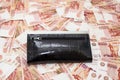 Black purse on scattered five thousandth banknotes of rubles Royalty Free Stock Photo