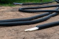 Black PVC electric pipes with wires on the ground. Construction site, power line with cable wires Royalty Free Stock Photo