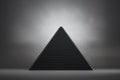 Black pyramid on grey background