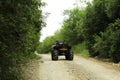 Black quad bike on pathway near trees outdoors