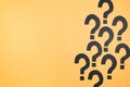 Black question marks on yellow cardboard Royalty Free Stock Photo