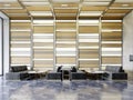 Black quilted sofas with a table in the waiting area against a backlit wooden wall