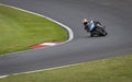 A black racing bike speeding round corners