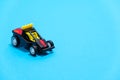 A black racing toy car on a blue background, a banner for a toy store with space for text Royalty Free Stock Photo