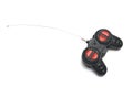 A black radio control RC remote controller with red buttons and a fine antenna