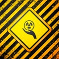 Black Radioactive in hand icon isolated on yellow background. Radioactive toxic symbol. Radiation Hazard sign. Warning