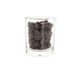 Black raisins in glass cup isolated on white background Royalty Free Stock Photo