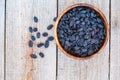 Black raisins in a wooden bowl. Royalty Free Stock Photo