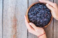 Black raisins in a wooden bowl. Royalty Free Stock Photo