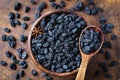 Black raisins in wooden bowl Royalty Free Stock Photo